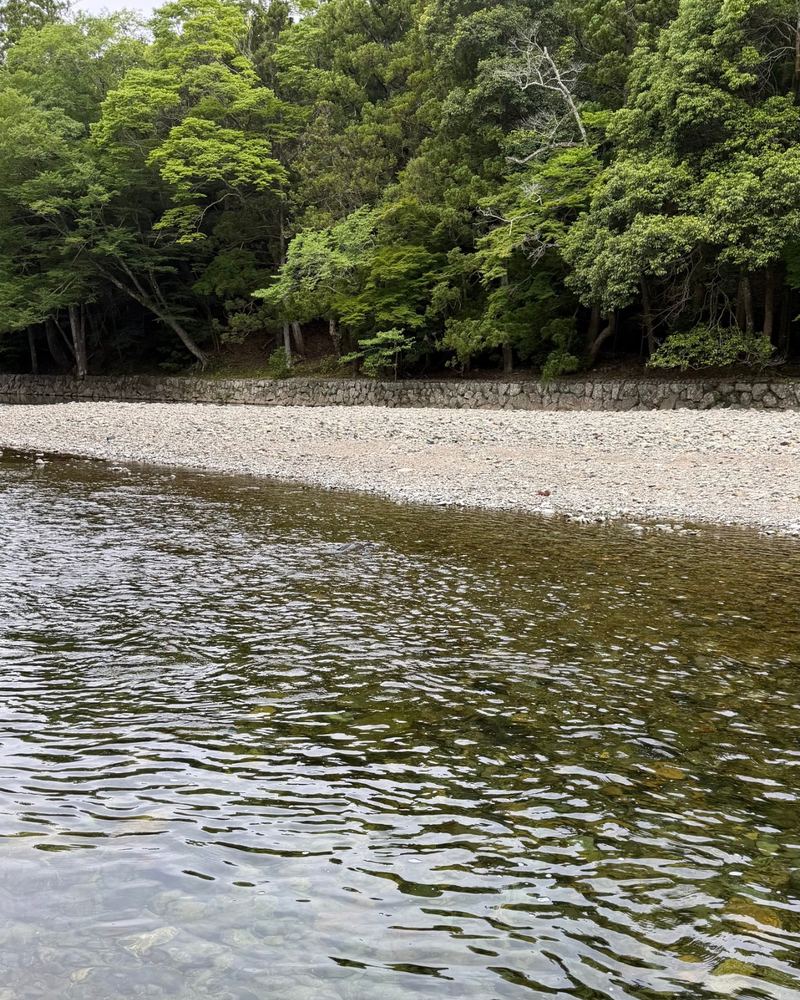 Clear river water and green forest inside the Ise Jingu grounds