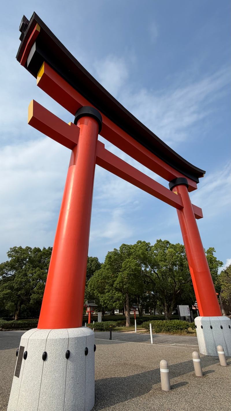 A huge red torii gate under a blue sky at Usa Jingu